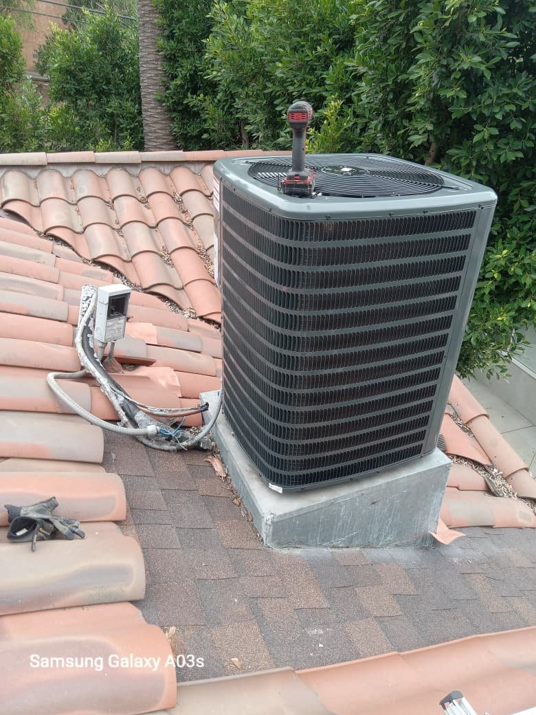 Air conditioning unit positioned on a residential roof